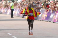 LONDON, ENGLAND - AUGUST 12: Stephen Kiprotich of Uganda celebrates as he approaches the line to win gold in the Men's Marathon on Day 16 of the London 2012 Olympic Games at The Mall on August 12, 2012 in London, England. (Photo by Michael Steele/Getty Images)