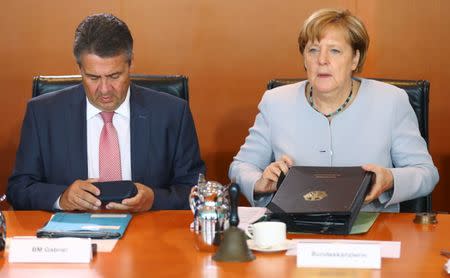 German Chancellor Angela Merkel and German Foreign Minister Sigmar Gabriel attend the weekly cabinet meeting at the Chancellery in Berlin, Germany June 28, 2017. REUTERS/Hannibal Hanschke