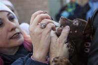 Front Street Animal Shelter's foster rescue coordinator Lori Rhoades gives deworming medication to a dog in Sacramento, California, in preparation for a flight of 50 dogs to a no-kill shelter in Idaho, December 9, 2013. REUTERS/Max Whittaker