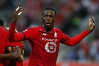 Lille's Timothy Weah celebrates after Lille's Jonathan David scored his side's opening goal during the French League One soccer match between Lille and Reims at the Stade Pierre Mauroy stadium in Villeneuve-d'Ascq, France, Wednesday, Sept. 22, 2021. (AP Photo/Michel Spingler)