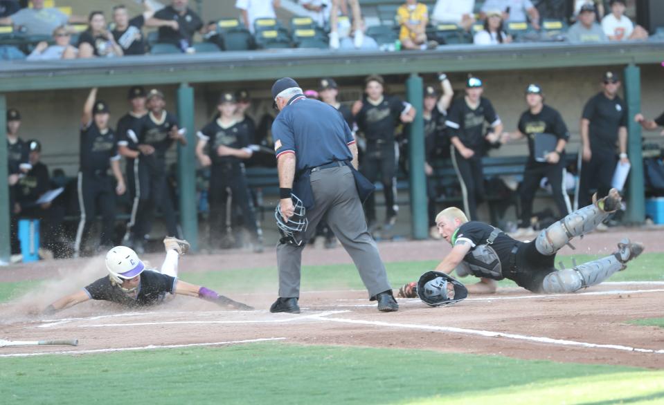 Calvary's Max Arnold safely slides in for the score past the tag of Mary Persons catcher Ryan Causey during the a semi-final game against Mary Persons on Friday, May 10, 2024 at Grayson Stadium.
