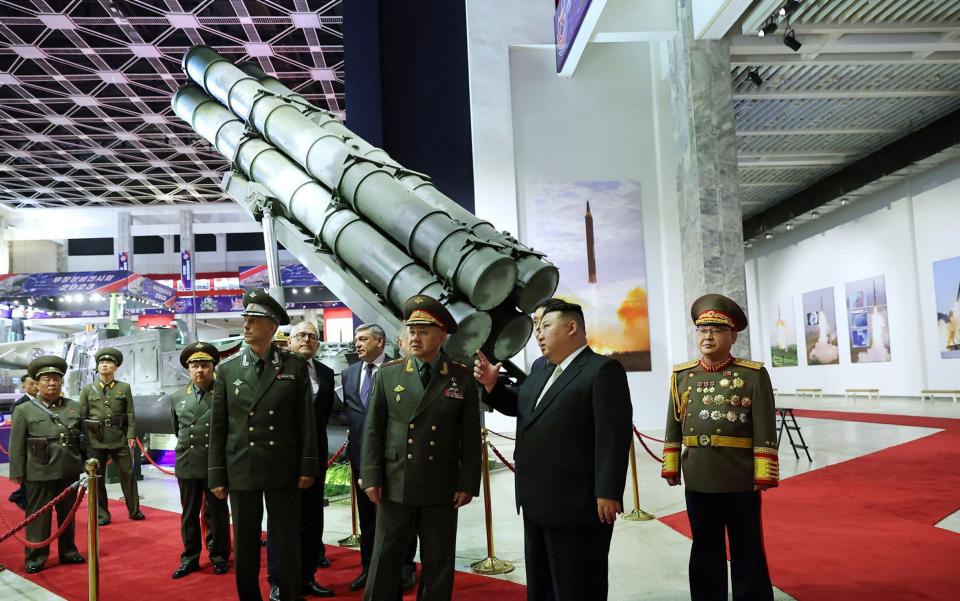 Kim Jong Un (second right) visiting the weaponry exhibition house with Sergei Shoigu (third right) and members of the Russian military delegation