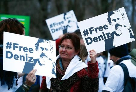 Protestors carry placards during a demonstration to support arrested German-Turkish journalist Deniz Yucel outside theTurkish Embassy in Berlin, Germany, February 28, 2017. REUTERS/Fabrizio Bensch