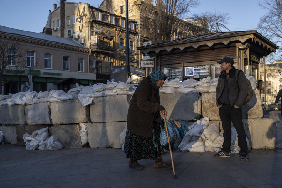 FIEL - An elderly woman walks pass concrete blocks topped with sandbags at a street in Odesa, southern Ukraine, on Tuesday, March 22, 2022. The Black Sea port is mining its beaches and rushing to defend itself from a Mariupol-style fate. Some Western officials believe the city, which is dear to Ukrainians' hearts, could be next. (AP Photo/Petros Giannakouris, File)
