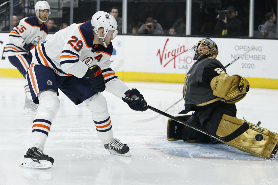 Edmonton Oilers center Leon Draisaitl (29) takes a shot on Vegas Golden Knights goaltender Marc-Andre Fleury (29) during the first period of an NHL hockey game Wednesday, Feb. 26, 2020, in Las Vegas. (AP Photo/John Locher)