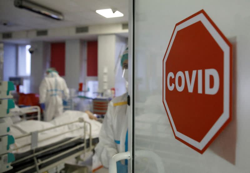 FILE PHOTO: Medical staff members treat patients inside the coronavirus disease (COVID-19) ward at the Interior Ministry Hospital in Warsaw