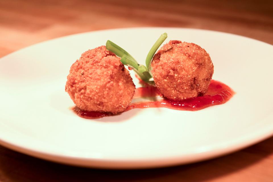 The pimento cheese fritters Elkmont Station in Farragut are served with a side of celery and a drizzle of red pepper jam.