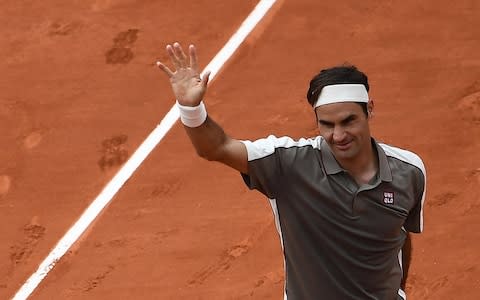 Federer salutes the crowd after his straight-sets win in the first round - Credit: AFP