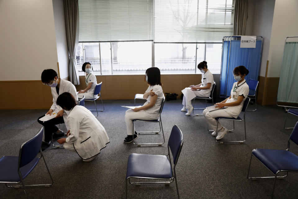 FILE - In this Feb. 17, 2021, file photo, medical workers wait for consultation after receiving a dose of the COVID-19 vaccine at Tokyo Medical Center in Tokyo. Frustration is mounting over Japanese Prime Minister Yoshihide Suga’s request that people cooperate while he pushes to hold the Olympics in just over two months. (Behrouz Mehri/Pool Photo via AP, File)