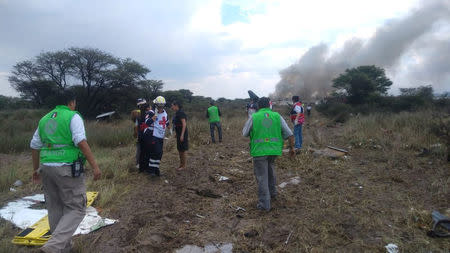 Emergency rescue personnel work at the site where an Aeromexico-operated Embraer passenger jet crashed in Mexico's northern state of Durango, July 31, 2018, in this picture obtained from social media. Proteccion Civil Durango/via REUTERS