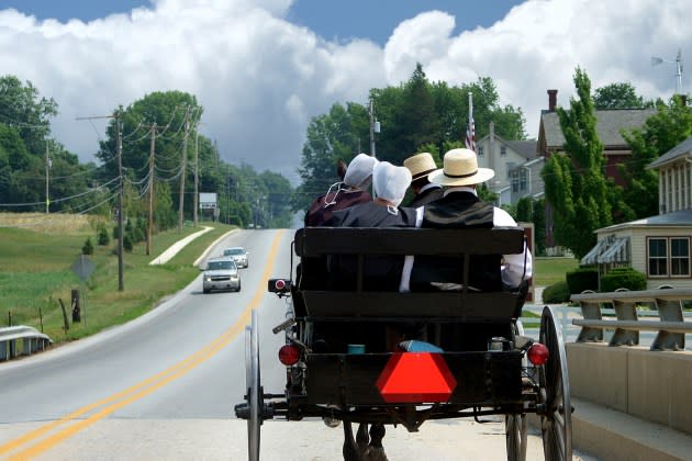 Plain people ride in a buggy in Lancaster County, Pennsylvania. - Credit: Getty Images