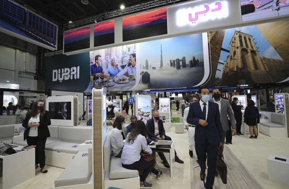 People visit the Arabian Travel Market exhibition in Dubai, United Arab Emirates, Sunday, May 16, 2021. The Middle East's largest airlines saw its passenger levels plummet by 70% last year and furloughed more than 25% of its staff due to the coronavirus pandemic, Emirates' chairman and chief executive said Monday. (AP Photo/Kamran Jebreili)