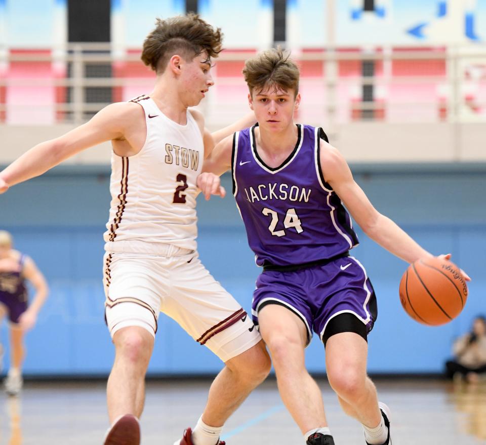 Jackson's Kyle Monterrubio drives against Stow's Tyler Fleishour in a Division I district final at Alliance High School, Saturday, March 4, 2023.