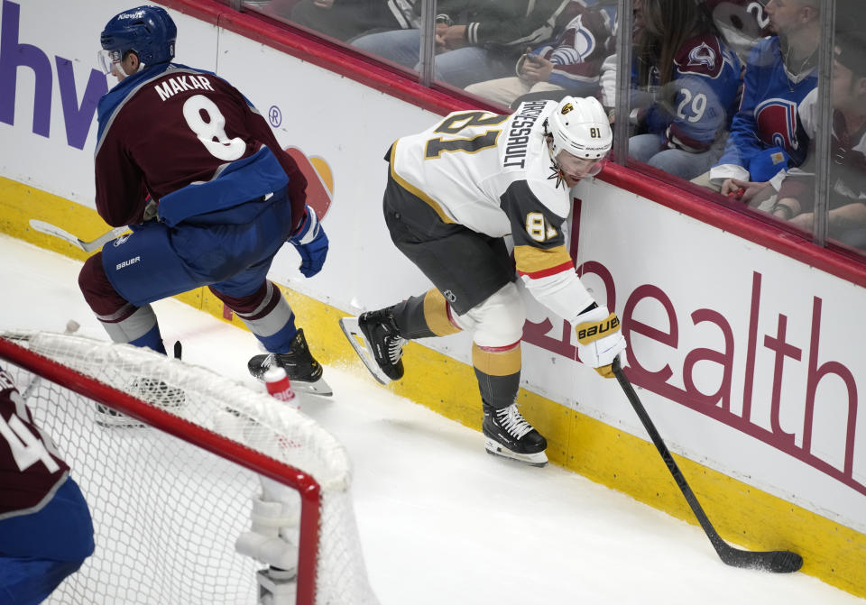 Vegas Golden Knights right wing Jonathan Marchessault, right, collects the puck next to Colorado Avalanche defenseman Cale Makar during the third period of an NHL hockey game Wednesday, Jan. 10, 2024, in Denver. (AP Photo/David Zalubowski)