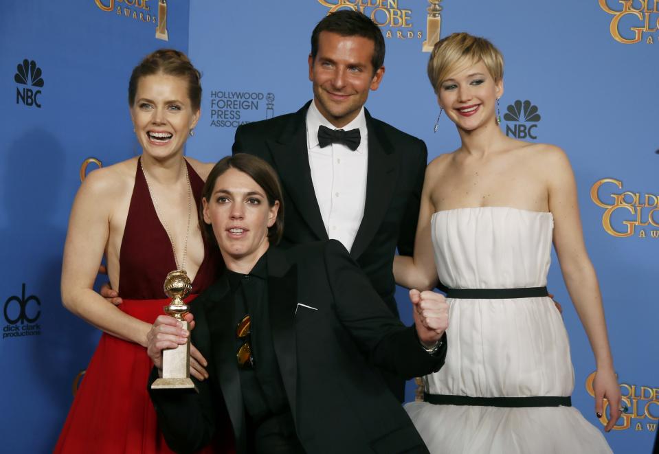 "American Hustle" stars Amy Adams (L), Bradley Cooper and Jennifer Lawrence (R) pose backstage with producer Megan Ellison after the film won the award for Best Motion Picture, Musical or Comedy at the 71st annual Golden Globe Awards in Beverly Hills, California January 12, 2014. REUTERS/Lucy Nicholson