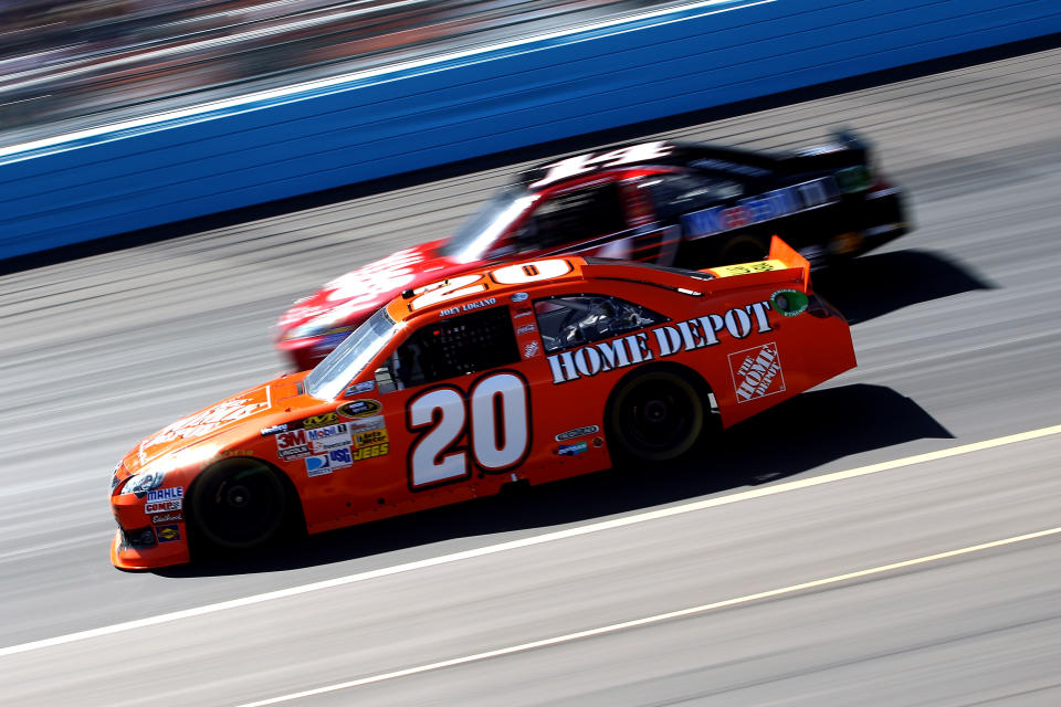 AVONDALE, AZ - MARCH 04: Joey Logano, driver of the #20 The Home Depot Toyota, drives alongside Tony Stewart, driver of the #14 Office Depot/ Mobil 1 Chevrolet, during the NASCAR Sprint Cup Series SUBWAY Fresh Fit 500 at Phoenix International Raceway on March 4, 2012 in Avondale, Arizona. (Photo by Christian Petersen/Getty Images)