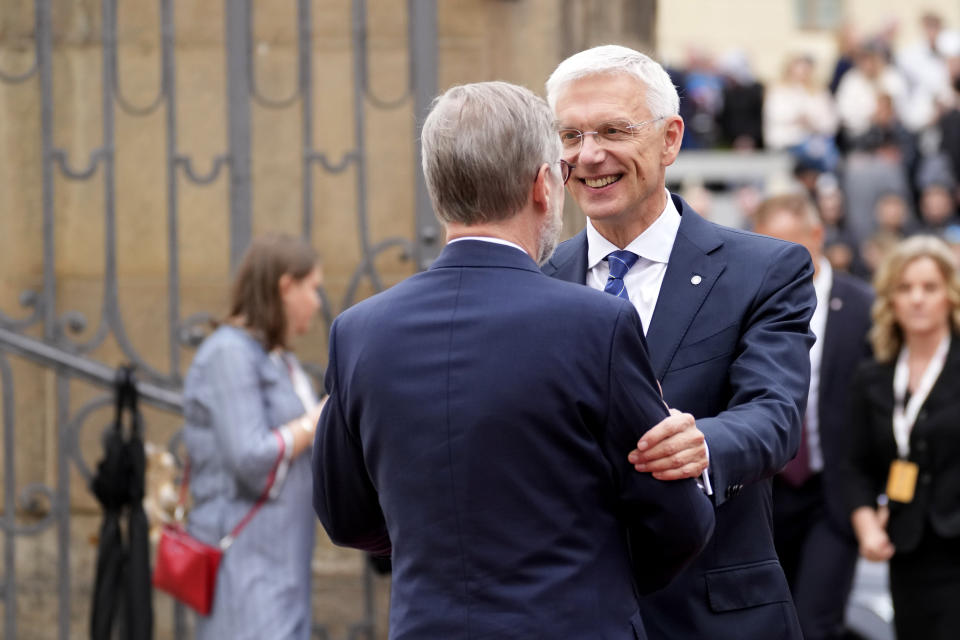 Latvia's Prime Minister Krisjanis Karins, right, is greeted by Czech Republic's Prime Minister Petr Fiala as he arrives for a meeting of the European Political Community at Prague Castle in Prague, Czech Republic, Thursday, Oct 6, 2022. Leaders from around 44 countries are gathering Thursday to launch a "European Political Community" aimed at boosting security and economic prosperity across the continent, with Russia the one major European power not invited. (AP Photo/Darko Bandic)