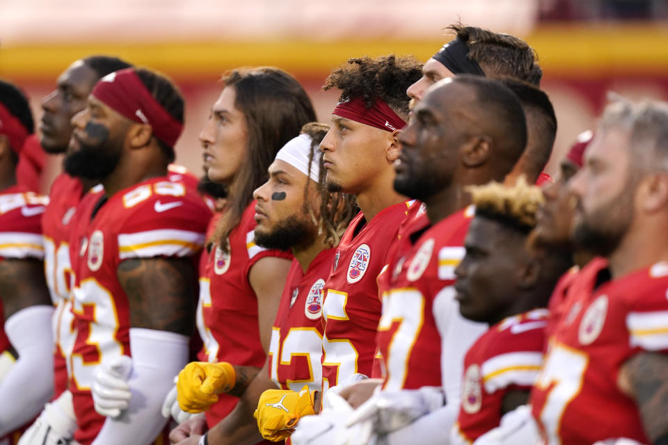 FILE - In this Thursday, Sept. 10, 2020 file photo, Kansas City Chiefs players, including quarterback Patrick Mahomes (15) stand with teammates for a presentation on social justice before an NFL football game against the Houston Texans, in Kansas City, Mo. The NFL's new stance encouraging players to take a stand against racial injustice got its first test as some fans of the Super Bowl champion Kansas City Chiefs booed during a moment of silence to promote the cause, touching off a fresh debate on how players should use their voice. (AP Photo/Charlie Riedel, File)