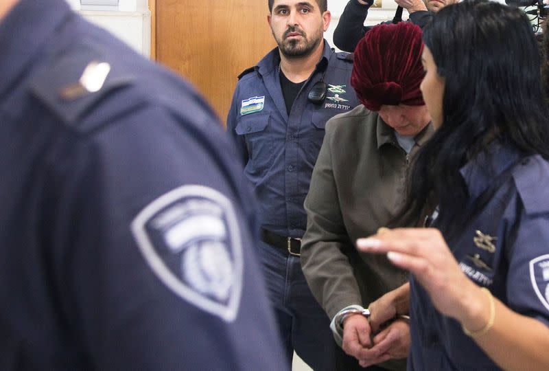 FILE PHOTO: Malka Leifer, a former Australian school principal who is wanted in Australia on suspicion of sexually abusing students, walks in the corridor of the Jerusalem District Court accompanied by Israeli Prison Service guards, in Jerusalem