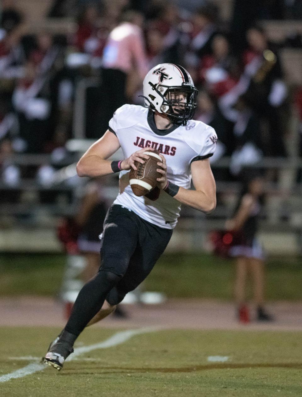 Quarterback John Nicholas (9) looks for an open receiver during the West Florida vs Tate football game at Tate High School in Cantonment on Friday, Oct. 6, 2023.