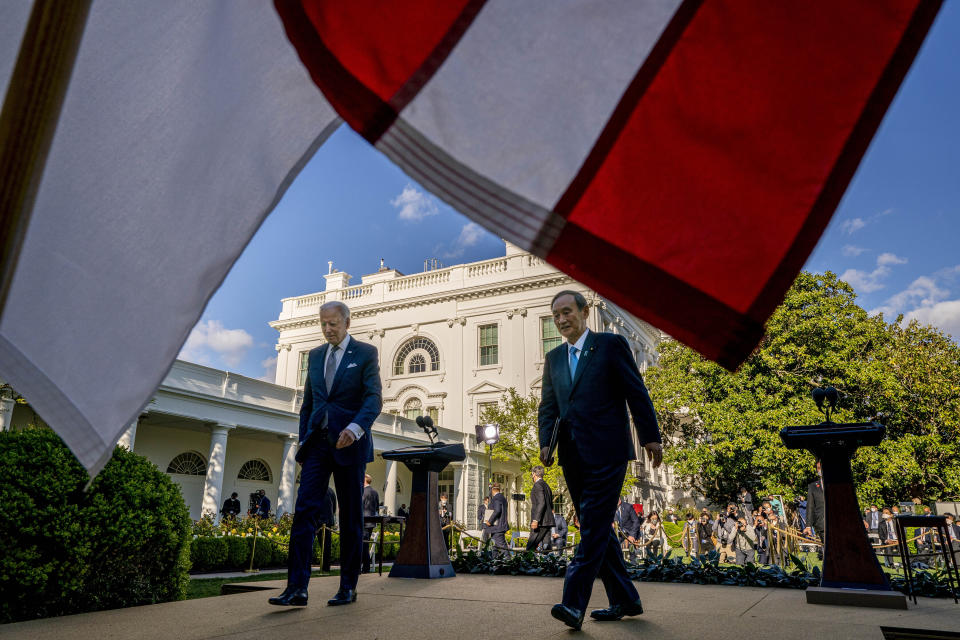 President Joe Biden and Japanese Prime Minister Yoshihide Suga leave a news conference in the Rose Garden of the White House in Washington, Friday, April 16, 2021. (AP Photo/Andrew Harnik)