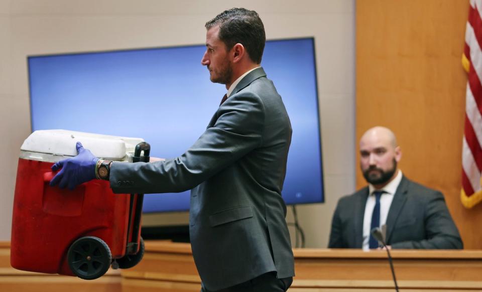 Assistant New Hampshire Attorney General Christopher Knowles shows a red cooler to the jury that had just been identified by witness Martin Orlowicz, a New Hampshire State Police Forensic Lab latent print examiner during Adam Montgomery's trial (AP)