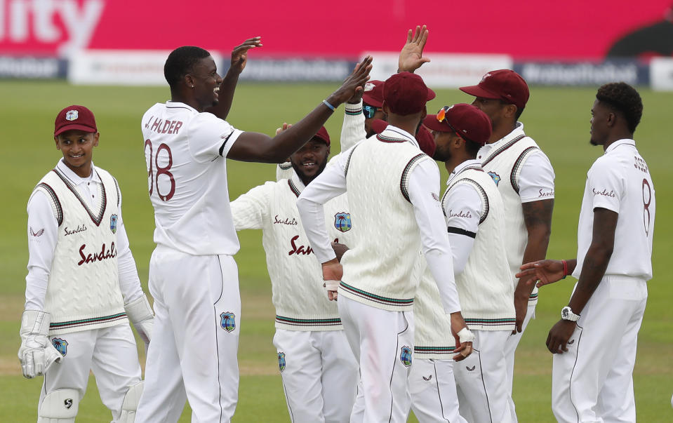 West Indies' captain Jason Holder, second left, celebrates with teammates the dismissal of England's Jofra Archer during the second day of the first cricket Test match between England and West Indies, at the Ageas Bowl in Southampton, England, Thursday, July 9, 2020.(Adrian Dennis/Pool via AP)