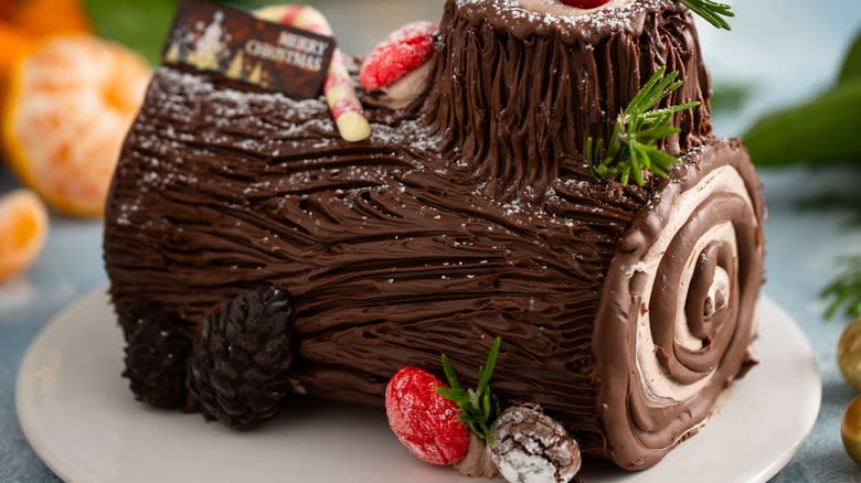 decorated Yule log cake on plate