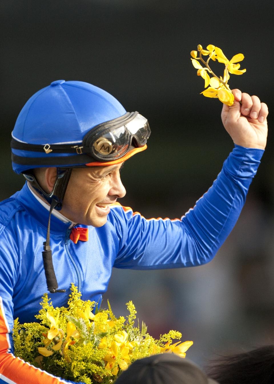 In a photo provided by Benoit Photo, jockey Mike Smith celebrates after guiding Game On Dude to victory in the $750,000 Santa Anita Handicap horse race, Saturday, March 8, 2014 at Santa Anita in Arcadia, Calif. (AP Photo/Benoit Photo)