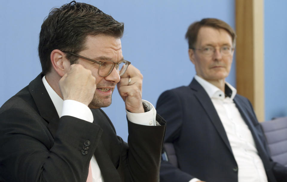 Karl Lauterbach, Federal Minister of Health, and Marco Buschmann, Federal Minister of Justice, answer questions from journalists and inform media representatives about new rules in the Infection Protection Act, which were previously approved by the cabinet in Berlin, Germany, Wednesday, Aug.24, 2022. (Wolfgang Kumm/dpa via AP)