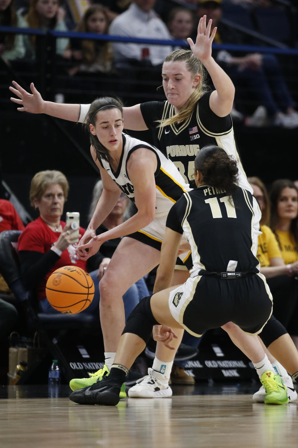 Purdue forward Caitlyn Harper, back right, and guard Lasha Petree (11) pressure Iowa guard Caitlin Clark during the first half of an NCAA college basketball game at the Big Ten women's tournament Friday, March 3, 2023, in Minneapolis. (AP Photo/Bruce Kluckhohn)