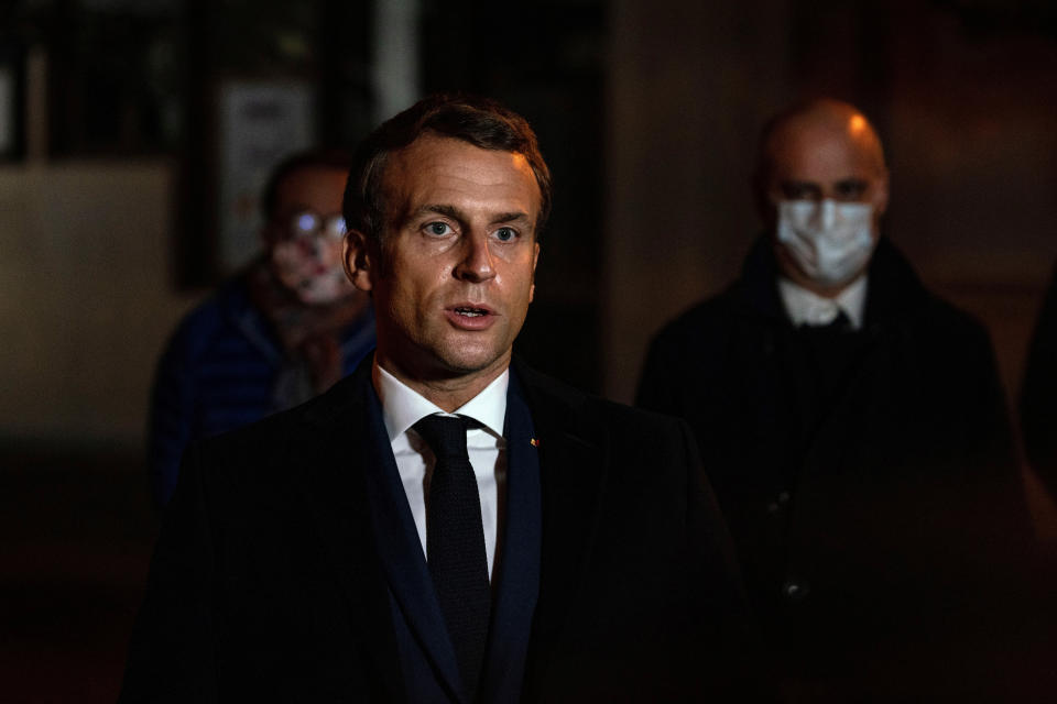 French President Emmanuel Macron speaks in front of a high school Friday Oct.16, 2020 in Conflans Sainte-Honorine, northwest of Paris, where a history teacher who opened a discussion with high school students on caricatures of Islam's Prophet Muhammad was beheaded. French President Emmanuel Macron denounced what he called an "Islamist terrorist attack" against a history teacher decapitated in a Paris suburb Friday, urging the nation to stand united against extremism. (Abdulmonam Eassa, Pool via AP)