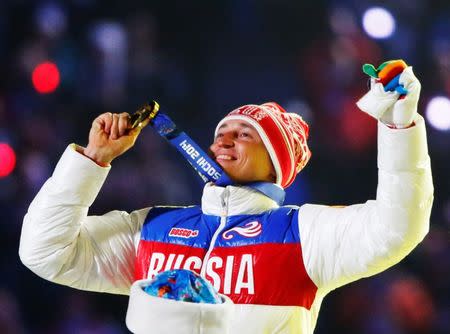 Russian gold medalist Alexander Legkov celebrates as he receives his medal for the men's cross-country 50-kilometer mass start race during the closing ceremony for the Sochi 2014 Winter Olympics, Russia, February 23, 2014. REUTERS/Lucy Nicholson/File Photo