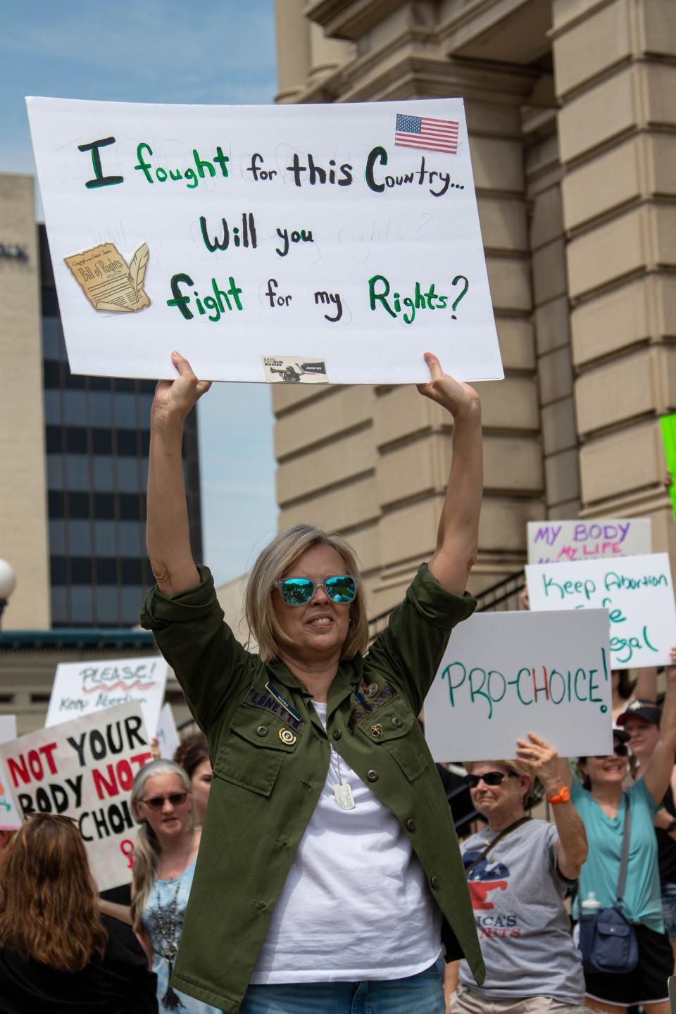 Outside of the Tippecanoe County Courthouse, a protester demonstrates as part of the nationwide "Bans Off Our Bodies" protest, against the potential Supreme Court decision that would overturn Roe v. Wade, on May 14, 2022, in Lafayette. "I fought for this Country... Will you fight for my rights?" reads the sign.