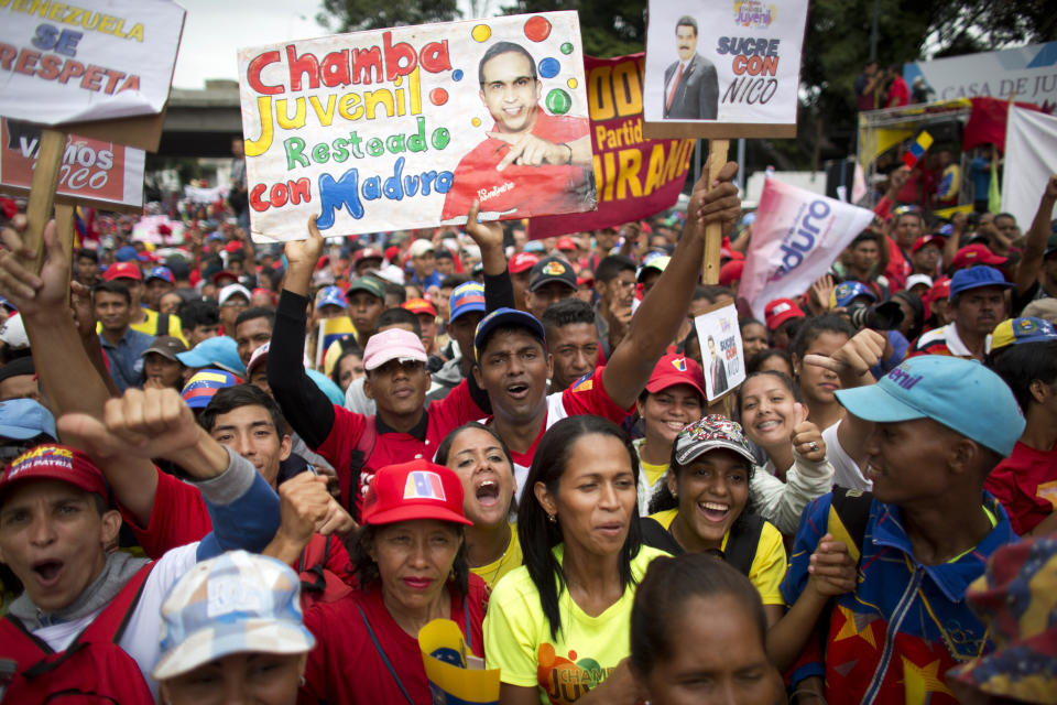 Supporters of Venezuela's President Nicolas Maduro rally in Caracas, Venezuela, Monday, Aug. 13, 2018. The United Socialist Party of Venezuela (PSUV) organized the rally to show support for the president following what the government called a failed assassination attempt with explosives-laden drones. (AP Photo/Ariana Cubillos)