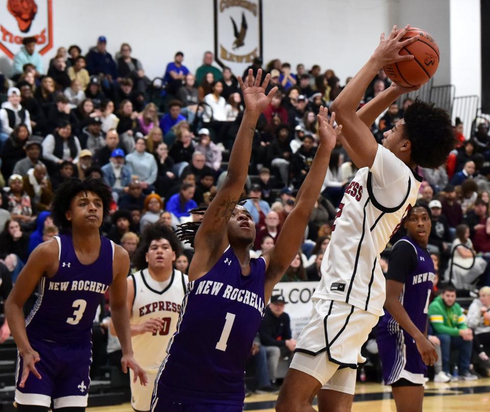 Elmira's James Harris goes up for a shot as New Rochelle's Lee Hesler defends during New Rochelle's 69-48 victory in a Boys National Division quarterfinal at the Josh Palmer Fund Clarion Classic on Dec. 28, 2023 at Elmira High School.