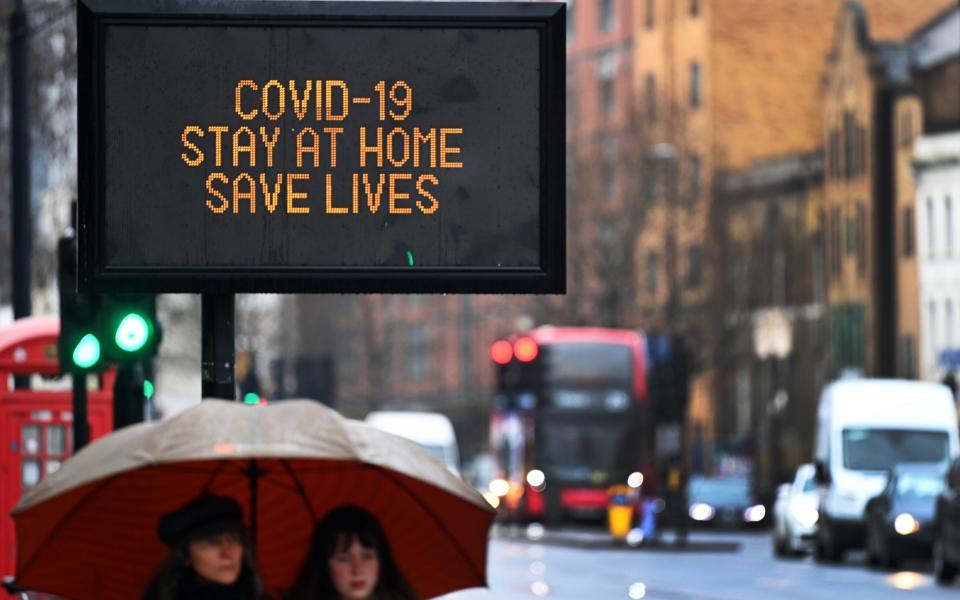 A Covid-19 public notice urging people to stay at home in London - Andy Rain/EPA-EFE/Shutterstock