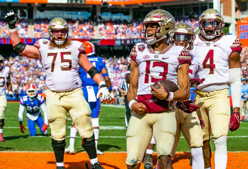 Florida State Seminoles quarterback Jordan Travis (13) celebrates his first half touchdown to tie the game 7-7. The Florida Gators hosted the Florida State Seminoles Saturday November 27, 2021 at Ben Hill Griffin Stadium in Gainesville, Florida. [Doug Engle/Ocala Star-Banner]2021