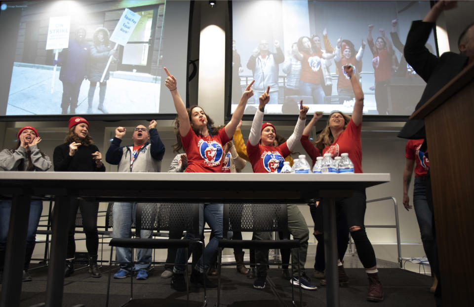 Supporters dance on stage during a news conference at the Chicago Teachers Union headquarters in Chicago on Sunday, Dec. 9, 2018. The nation's first teachers' strike against a charter school operator will end after their union and management struck a tentative deal Sunday that includes protections for students and immigrant families living in the country illegally. (Colin Boyle/The Beacon-News via AP)