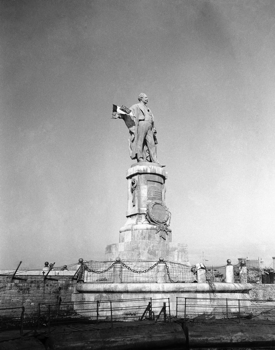 FILE - This Dec. 22, 1956 file photo, shows the statue of Ferdinand de Lesseps, the French diplomat who was behind the construction of Egypt's Suez Canal, in the harbor of Port Said, Egypt. A proposal to bring back the statue has stirred controversy in Egypt with many saying it would be a salute to colonial times and a “humiliation" to the memory of tens of thousands of Egyptian laborers who died while digging the waterway. The debate started when a newspaper reported in June 2020 that local authorities in the Mediterranean province of Port Said were thinking of returning the statue to where it once stood at the northern entrance of the canal. (AP Photo/Jim Pringle, File)