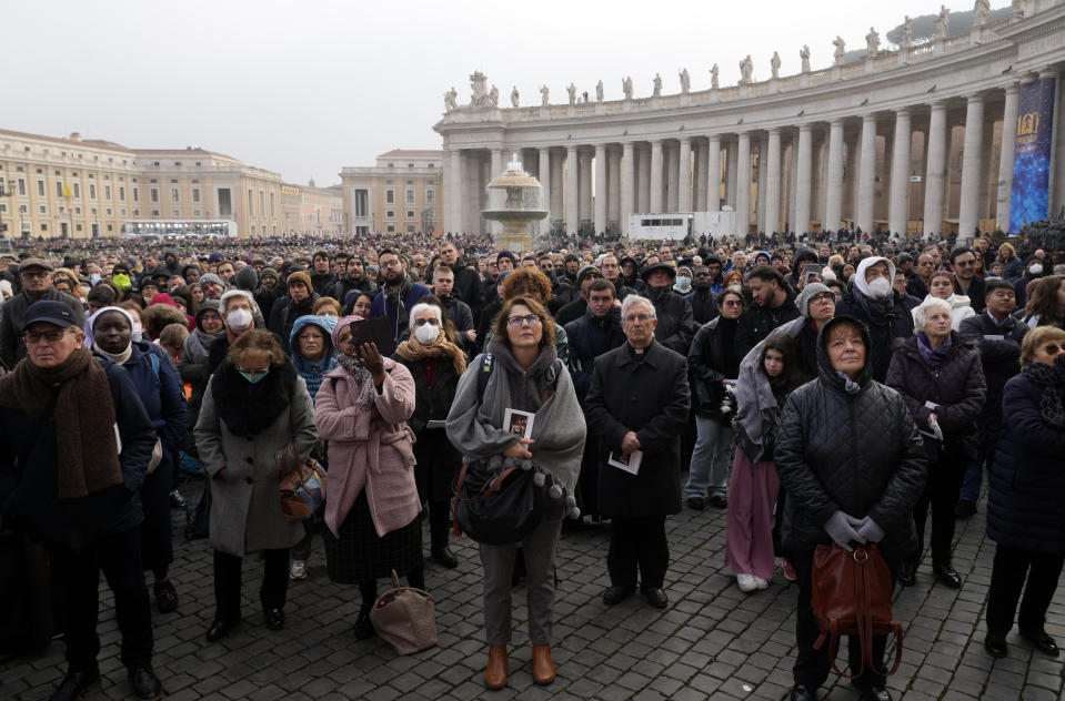Faithful attend the funeral mass for late Pope Emeritus Benedict XVI in St. Peter's Square at the Vatican, Thursday, Jan. 5, 2023. Benedict died at 95 on Dec. 31 in the monastery on the Vatican grounds where he had spent nearly all of his decade in retirement. (AP Photo/Gregorio Borgia)