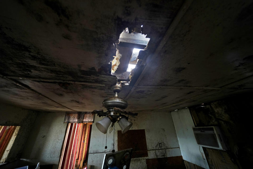 Holes in the ceiling and mold are seen inside the home of Irene Verdin, which was heavily damaged by Hurricane Ida in August 2021, along Bayou Pointe-au-Chien, La., Tuesday, May 24, 2022. (AP Photo/Gerald Herbert)