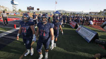 Herriman players take the field for a high school football game against Davis on Thursday, Aug. 13, 2020, in Herriman, Utah. Utah is among the states going forward with high school football this fall despite concerns about the ongoing COVID-19 pandemic that led other states and many college football conferences to postpone games in hopes of instead playing in the spring. (AP Photo/Rick Bowmer)