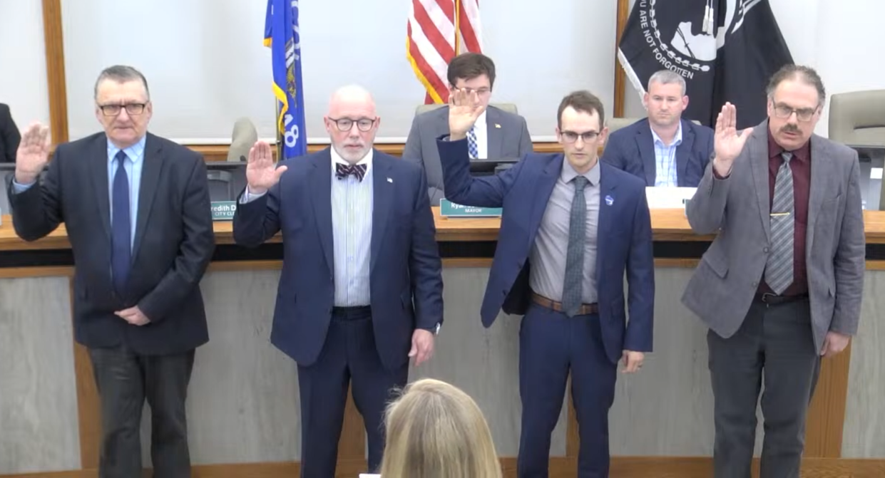 (from left to right) Robert La Fave, John Belanger, Zachary Rust and Dean Dekker are sworn into office April 16.