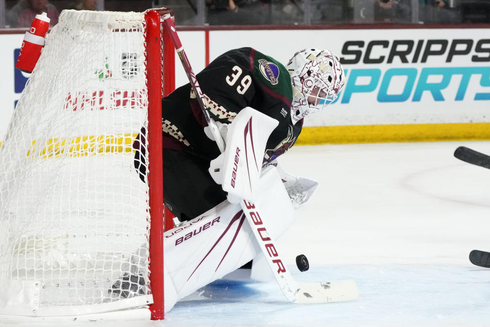 Arizona Coyotes goaltender Connor Ingram makes a save against the San Jose Sharks during the second period of an NHL hockey game Friday, Dec. 15, 2023, in Tempe, Ariz. (AP Photo/Ross D. Franklin)