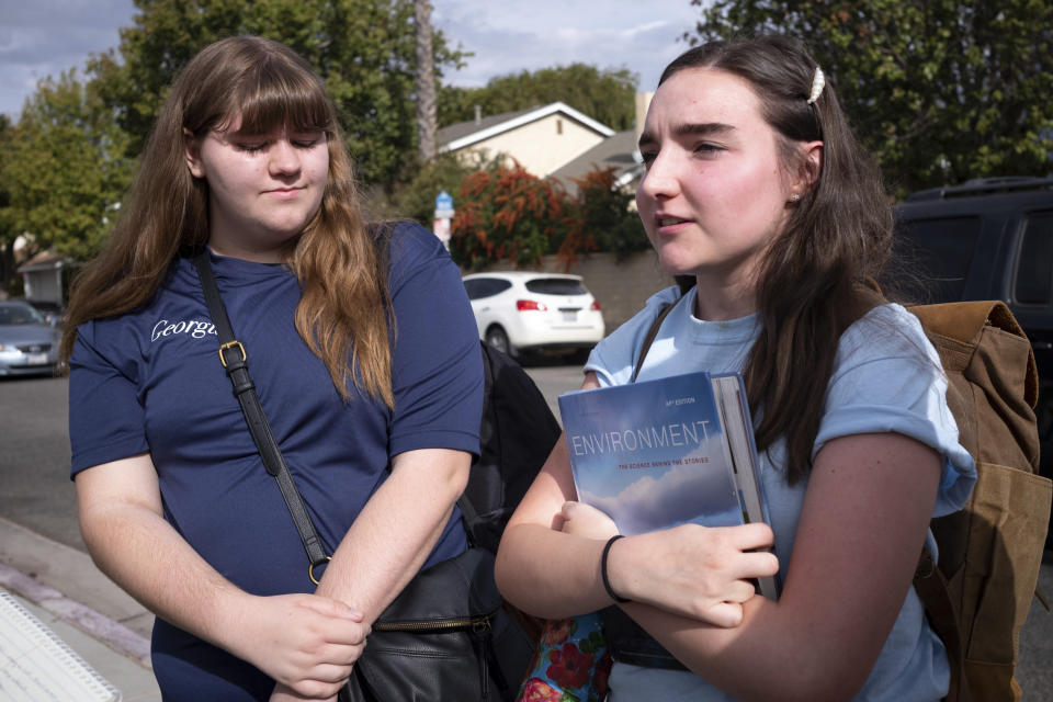 Saugus high students Georgia McDow, left, and Audrey Marshall, both 17, talk about going back on campus at Saugus high Tuesday, Nov. 19, 2019. Students were allowed back to collect their belongings left behind after the tragic shooting last Thursday. Classes will resume at the high school on Dec. 2. (David Crane/The Orange County Register via AP)