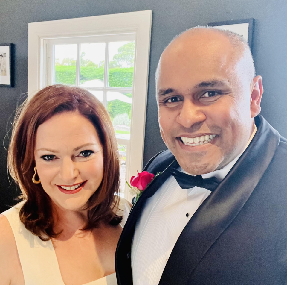 Mr Jayarajah wearing a suit and his wife Emma in a white dress.