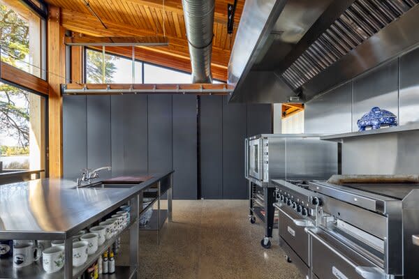 The light-filled kitchen features professional-grade, stainless-steel appliances.