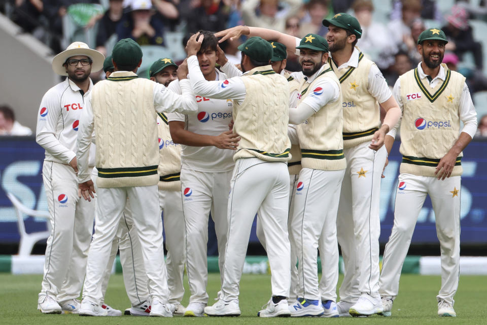 Pakistan's Mir Hamza, forth left, celebrates with teammates after bowling out Australia's Travis Head during the third day of their cricket test match in Melbourne, Thursday, Dec. 28, 2023. (AP Photo/Asanka Brendon Ratnayake)