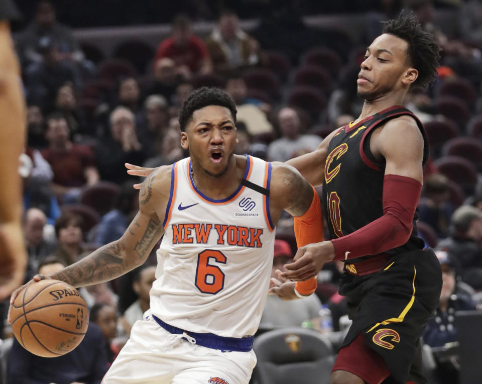 New York Knicks' Elfrid Payton (6) drives past Cleveland Cavaliers' Darius Garland (10) in the second half of an NBA basketball game, Monday, Jan. 20, 2020, in Cleveland. New York won 106-86. (AP Photo/Tony Dejak)
